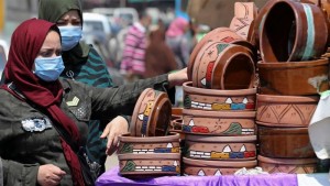 Women shop at a market wearing protective face masks amid concerns over COVID-19 in Cairo, Egypt on April 12, 2020 [Mohamed Abd El Ghany/Reuters]